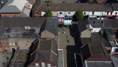 Aerial-view-looking-down-over-small-town-market-high-street-retail-shops-during-inflation