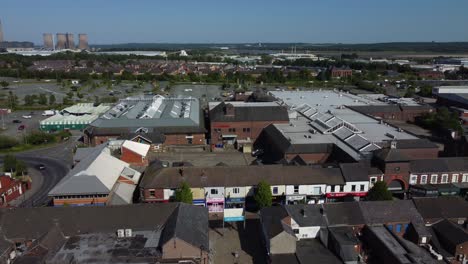 Aerial-view-above-small-town-retail-shopping-market-street-rooftops-during-British-inflation-crisis