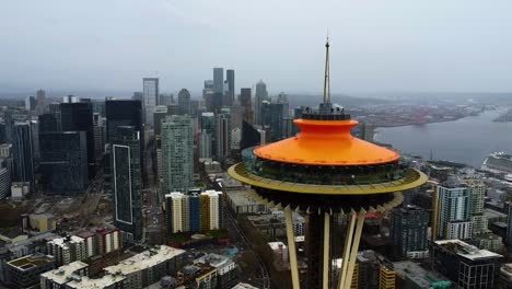 Aerial-view-away-from-the-Space-Needle-in-gloomy-Seattle-city,-USA---pull-back,-drone-shot