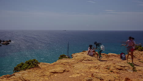 People-taking-photos-on-a-cliff-above-the-sea-in-Malta