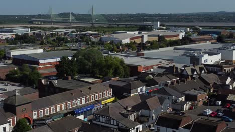 Aerial-view-above-small-town-streets-retail-shops-and-supermarket-rooftops-during-economy-crisis