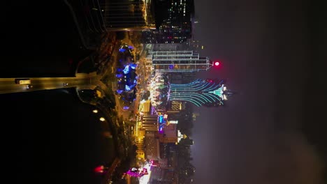 Vertical-aerial-view-approaching-Grand-Lisboa-Hotel-at-night