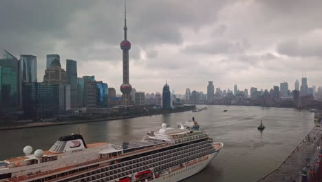 Viking-Sun-Cruise-Ship-at-Port-with-Skyline-in-Background-in-Shanghai,-China