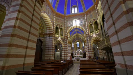 Central-nave-with-altar-in-background-and-blue-dome,-Santa-Maria-Assunta-church,-Soncino-in-Italy