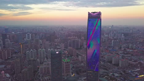 Aerial-Shot-of-W-Hotel-and-Sinar-Mas-Tower-with-Skyline-in-Background-in-Shanghai,-China