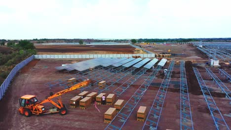 aerial-camera-followed-the-process-of-working-at-a-solar-farm-located-in-Gujarat,-India