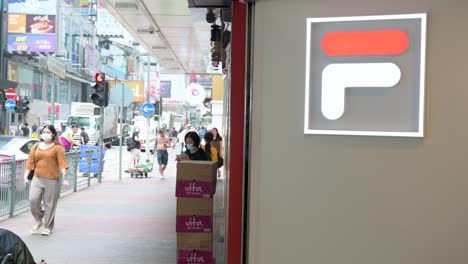 Chinese-pedestrians-walk-past-the-Italian-sportswear-goods-brand-Fila-store