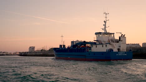 French-ship-CASAM-IV-general-cargo-entering-its-home-port-at-dusk,-View-from-boat