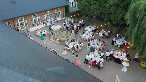 drone-shot-of-people-sitting-at-the-tables-and-eating-at-a-wedding-party