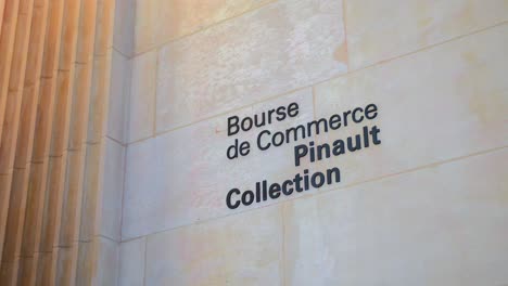 Bourse-de-Commerce-Writing-At-The-Entrance-Wall-With-The-Exhibition-Of-The-Pinault-Collection-In-Paris,-France