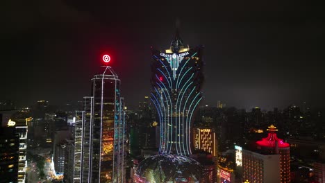 Aerial-view-approaching-Grand-Lisboa-Hotel-at-night