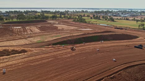 Yarrawonga,-Victoria,-Australia---2-June-2023:-Tracked-forklift-moving-through-earthworks-to-drop-off-a-concrete-pit-in-new-residential-stage-at-Silverwoods-Estate