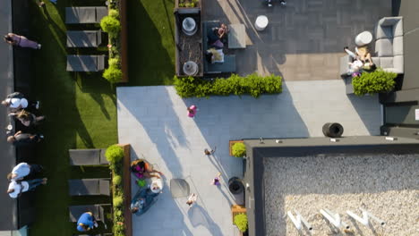 Aerial-view-over-people-enjoying-a-sunny-day-in-a-terrace-apartment-in-New-York,-USA---top-down,-drone-shot