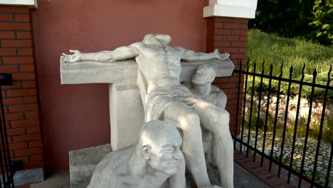Statue-of-Jesus-falling-on-the-cross,-station-of-the-Cross-in-Gietrzwałd
