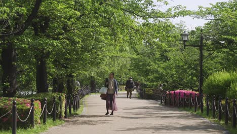 People-Walking-On-The-Pathway-At-Ueno-Park-In-Uenokoen,-Taito-City,-Tokyo,-Japan