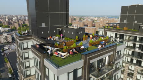 New-York-livestyle,-people-relaxing-on-top-of-a-condo-on-a-sunny-day---Aerial-view