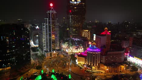 Tilt-up-aerial-reveal-of-Grand-Lisboa-Macau-at-night