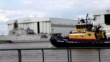 Yellow-and-red-tugboat-moving-in-Mobile-Bay-in-Mobile,-Alabama-with-stable-video