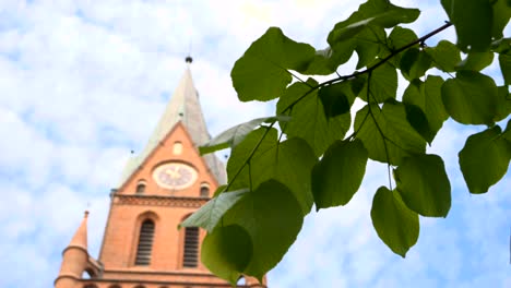 Tower-of-the-Sanctuary-of-Our-Lady-of-Gietrzwałd-seen-through-the-leaves