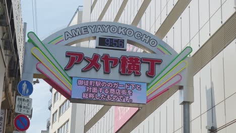 Close-up-view-of-the-entrance-arch-to-the-Ameyoko-candy-store-alley,-Ameya-Yokocho,-which-is-also-a-clock