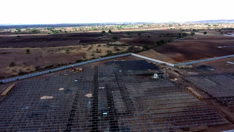 Aerial-landscape-view-of-installation-process-running-at-solar-farm-located-in-India