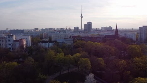 Aerial-over-Volkspark-Friedrichshain-with-fall-foliage,-Berlin-cityscape-view