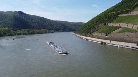 Aerial-shot-of-industrial-tanker-cargo-ship-barge-cruising-upstream-on-Rhine-river-in-Germany