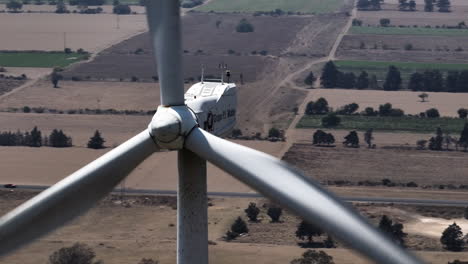 Aerial-parallax-shot-around-a-wind-turbine,-in-the-Eolic-Park-of-Esperanza,-Puebla,-Mexico