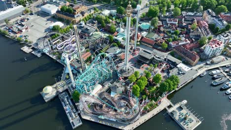 Grona-Lund-amusement-park-and-Tivoli-in-Djurgarden-island-at-Stockholm-city-in-Sweden---High-angle-summer-aerial-looking-down-at-rollercoasters-and-park-during-summer-sunshine