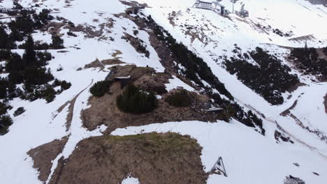 2-Male-Hikers-on-Snowy-Mountain-Slope,-Aerial-Dolly-Out-Reveal