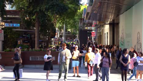 Dynamic-zoom-in-shot-capturing-bustling-downtown-Brisbane,-large-crowds-of-people-strolling-and-shopping-at-iconic-Queen-street-mall-on-a-sunny-day,-Queensland,-the-sunshine-state-of-Australia