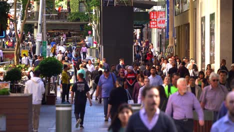 Swarm-of-people-in-bustling-downtown-Brisbane,-large-crowds-of-people-strolling-and-shopping-at-iconic-Queen-street-mall-on-a-sunny-day,-Queensland,-the-sunshine-state-of-Australia
