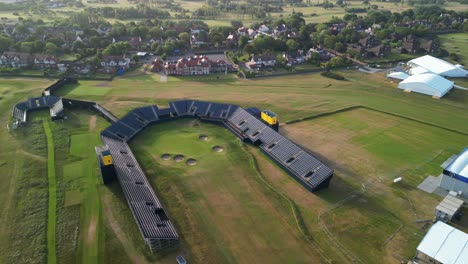 Preparations-for-The-2023-Open-at-Royal-Liverpool-Golf-Club,-Wirral,-UK---Aerial-drone-18th-green-clockwise-medium-distance-pan-and-pull-out,-course-reveal