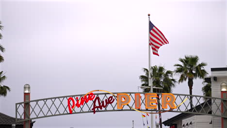 The-Pine-Ave-Pier-sign-at-Long-Beach,-California-USA-establishing-shot