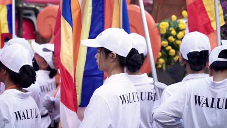 People-holding-buddhist-flag-on-vesak-day-parade-celebration-in-Indonesia