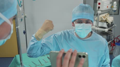 The-surgeon's-triumphant-gesture-in-the-operating-room