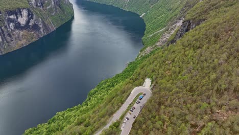 Famous-Geiranger-Fjord-and-Ornesvingen-viewpoint-at-the-eagles-road---Aerial-view-with-tilt-up-in-the-end
