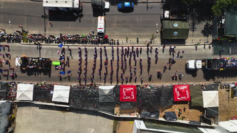 Aerial-view-above-a-parade-at-the-Carnival-of-Barranquilla,-in-sunny-Colombia---top-down,-drone-shot