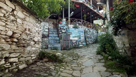 Woman-tourist-walks-down-cobbled-street-scene-in-Turkish-village-of-Sirince