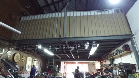 Tilting-shot-of-a-motorcycle-in-a-workshop-for-bikes