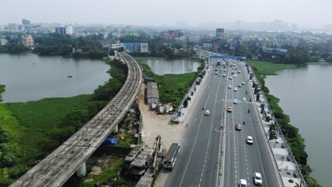 Aerial-view-of-highways-of-Kolkata-with-Nalban-lake-and-East-west-Metro-railways-under-construction