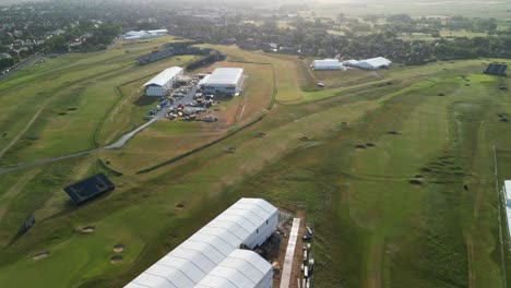 Preparations-for-The-2023-Open-at-Royal-Liverpool-Golf-Club,-Wirral,-UK---Aerial-drone-course-flyover,-focus-to-clubhouse