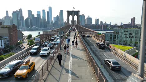 People-walking-on-Brooklyn-Bridge-in-Brooklyn,-New-York
