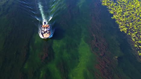 A-boat-with-fishermen-on-a-clear-channel-of-the-pantanal-in-Brazil