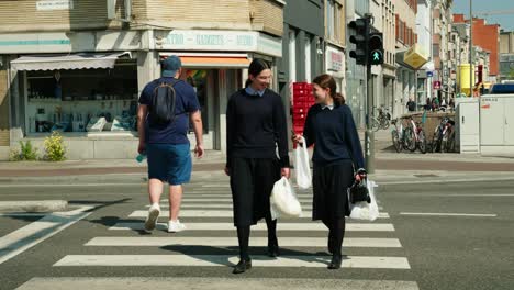 Happy-young-Orthodox-Jewish-girls-walking-in-the-famous-Antwerp's-diamond-district,-Belgium---Slow-motion