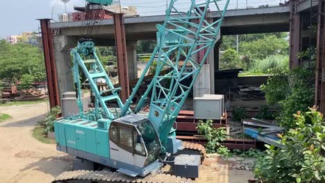 A-soil-digger-and-some-heavy-machinery-tools-around-a-construction-site-near-Science-City-canal,-doing-project-works-of-Metro-railway-extension