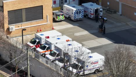 Aerial-top-down-shot-showing-hospital-in-Lancaster-with-parking-ambulance-vehicle-during-daytime---Pennsylvania,-America