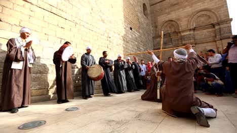 Artists-perform-an-Egyptian-traditional-dance-and-play-drums-at-the-opening-ceremony-of-the-5th-International-Festival-of-Drums-and-Traditional-Arts-in-Al-Moez-Street,-Cairo,-Egypt,-April-21,-2017