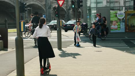Orthodox-Jewish-children-with-Kippah-hat-and-scooter-walking-in-the-famous-Antwerp's-diamond-district,-Belgium---Slow-motion