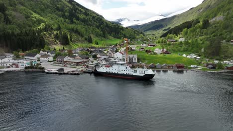 Ferry-Haroy-loading-cars-at-Eidsdal-with-cars-from-Geiranger-Norway-at-Eidsdal-to-Linge-ferry-crossing---Backward-moving-aerial-during-sunny-spring-day